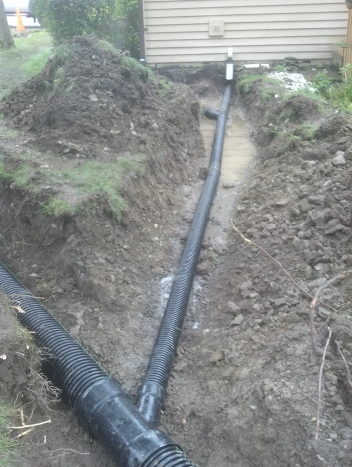 Drainage piping from side of home to Y-pipe in a trenching